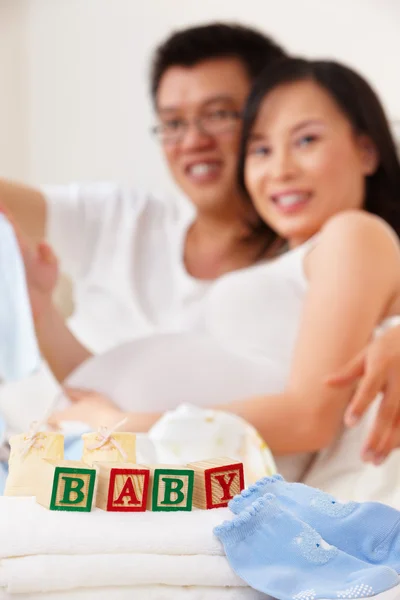 Word baby in front of asian couple — Stock Photo, Image