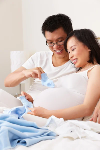Asiatisches Paar spielt Socken über ungeborenes Baby — Stockfoto