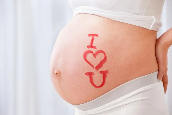 Symbol I love you on pregnanct stomach — Stock Photo, Image