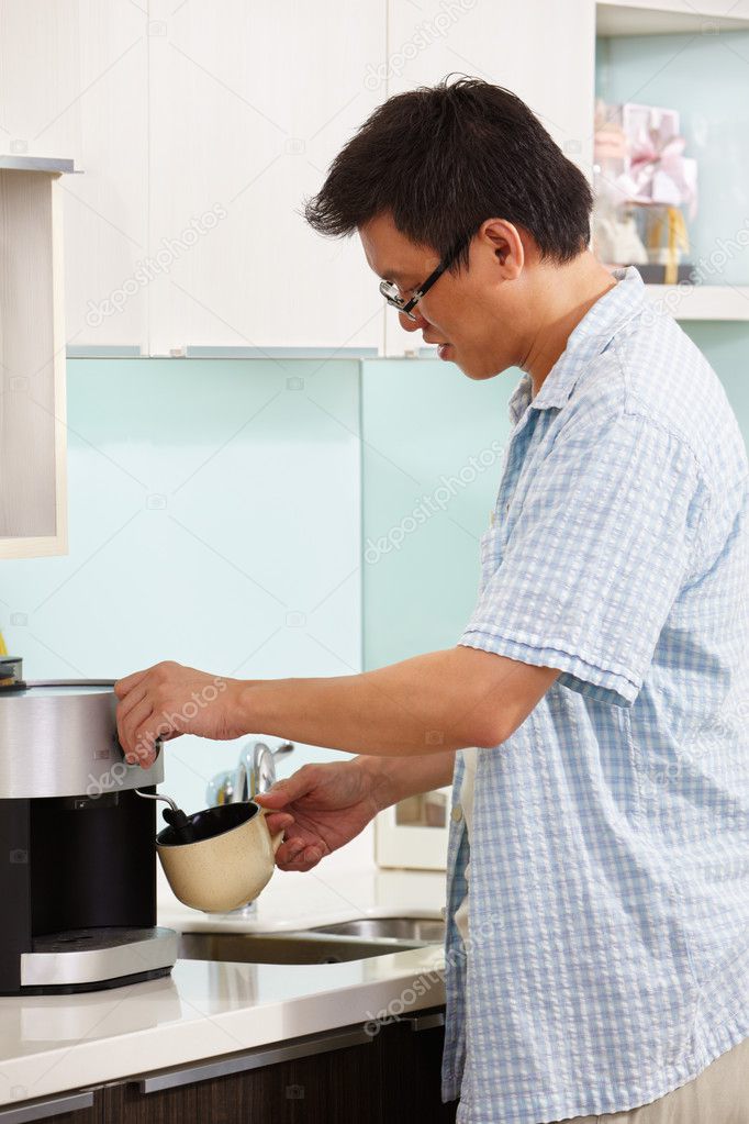 Asian male making coffee