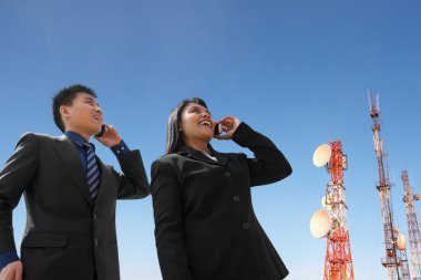 Asian business on phone and antenna clipart