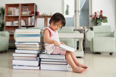 Litlle girl reading lot of books clipart