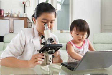 Mother and daughter busy on their own clipart