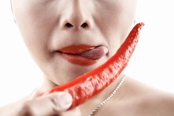 Woman tasting big red chili — Stock Photo, Image