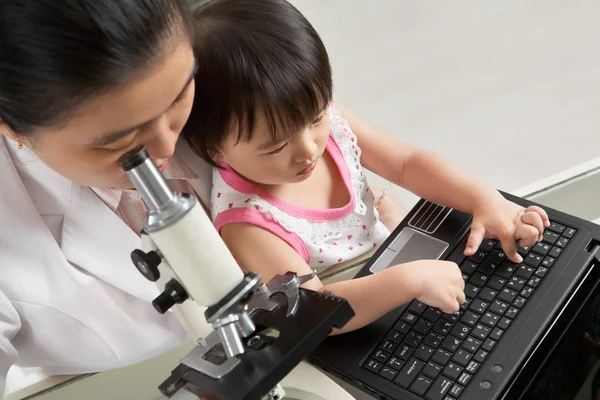 Mother and daughter busy on their own — Stock Photo, Image