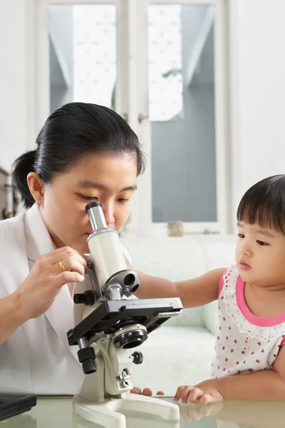 Little girl trying to distract her mom concentration — Stock Photo, Image