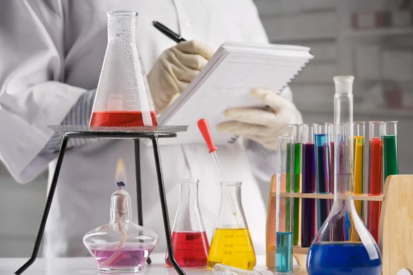 Scientist making notes in laboratory — Stock Photo, Image