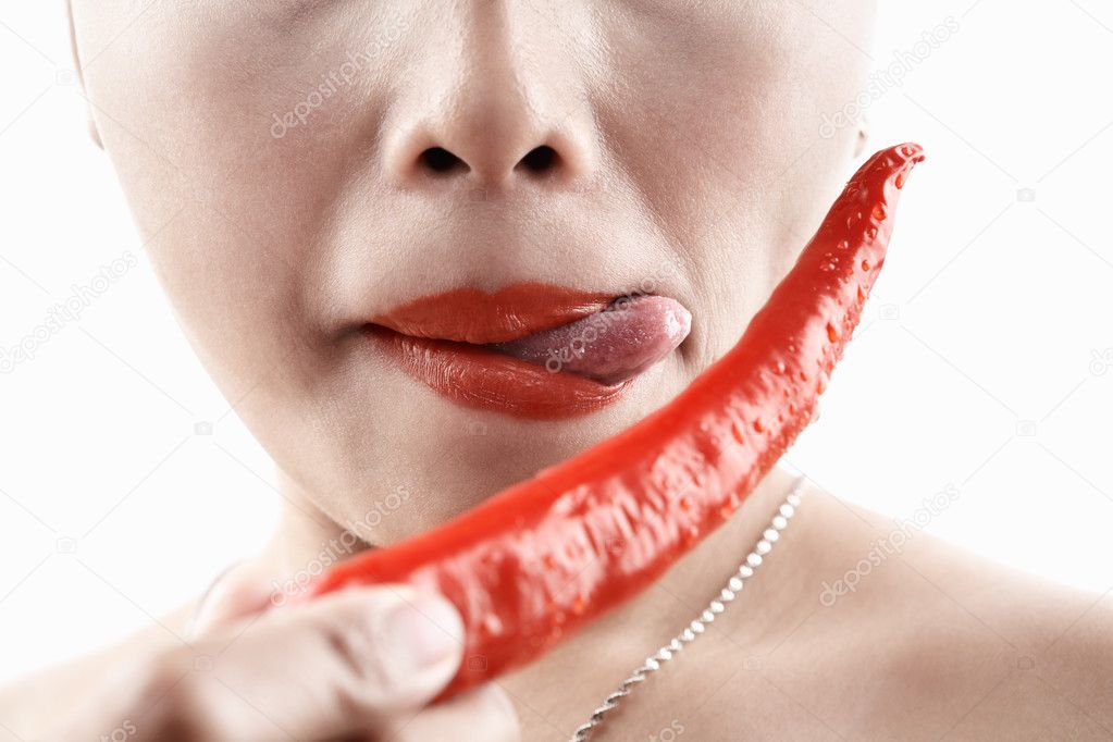 Woman tasting big red chili