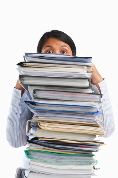 Female face behing pile of paper — Stock Photo, Image