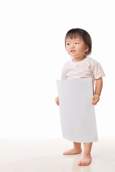 Asian female toddler holding white paper — Stock Photo, Image