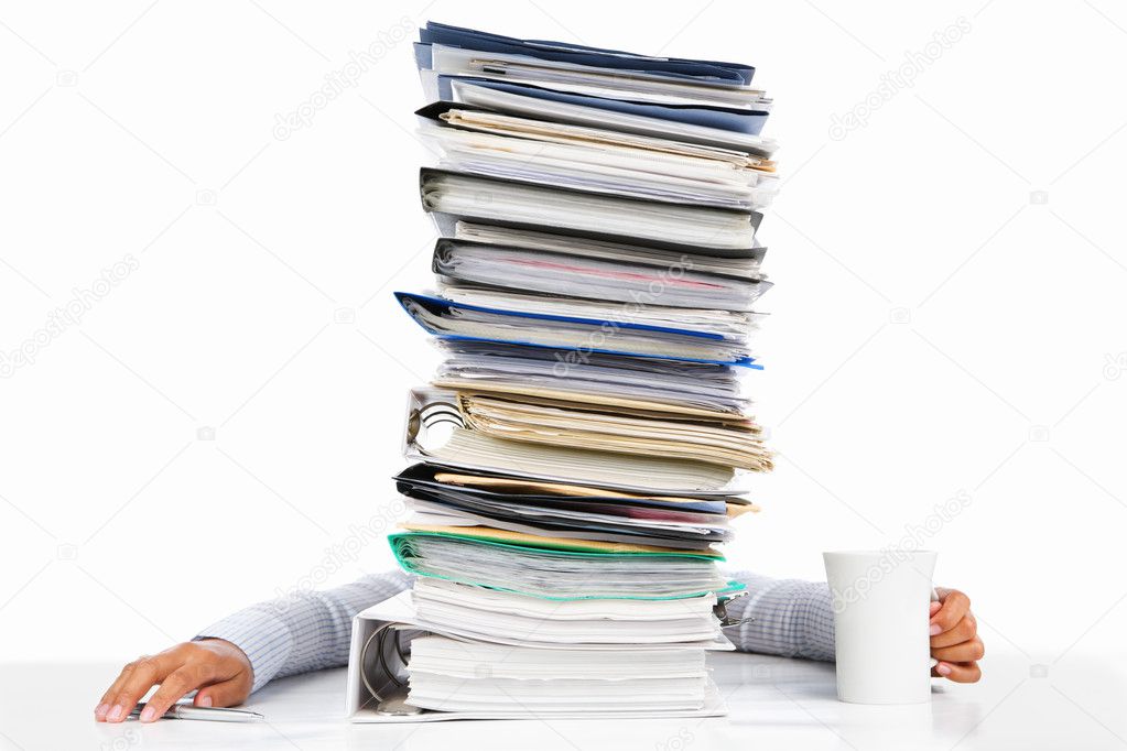Sleeping worker behing high pile of paperwork