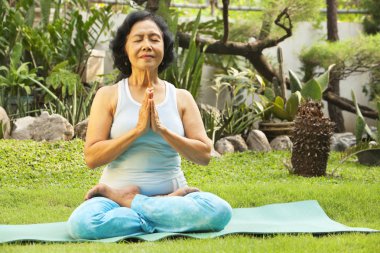 Senoir woman meditating clipart