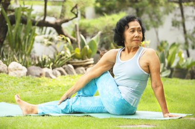 Asian senior old woman doing yoga clipart