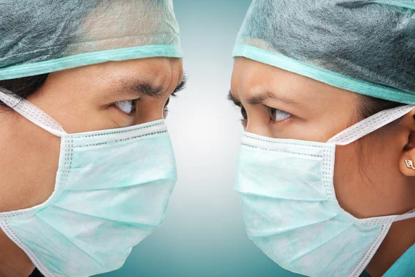 Serious looking between two medical worker — Stock Photo, Image