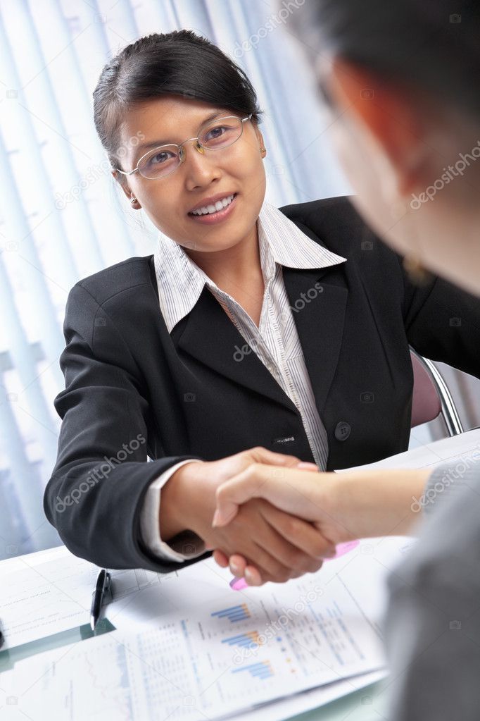 Asian businesswoman handshake with client