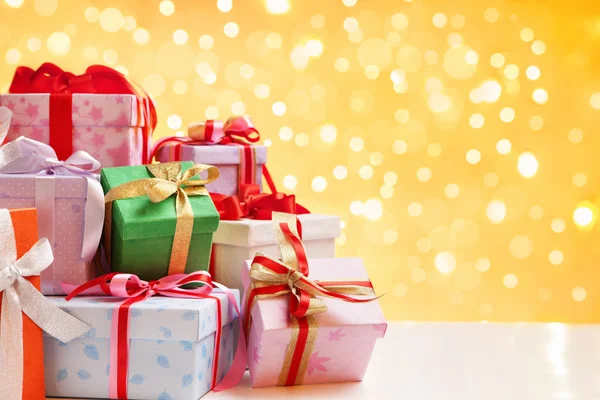Heap of Christmas gift over blur light — Stock Photo, Image