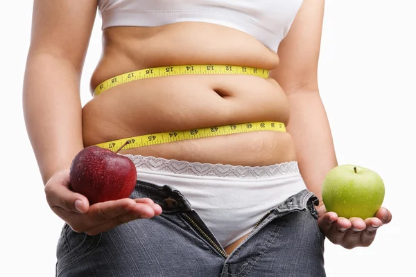 Fat woman with unzip jeans holding apple — Stock Photo, Image