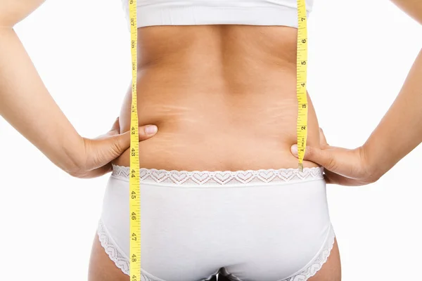 Femme dos avec de la cellulite et du ruban à mesurer — Photo