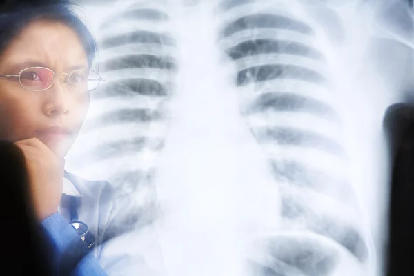 Aziatische vrouwelijke arts druk bezig x-ray resultaat — Stockfoto
