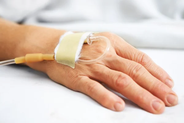 Old woman hand with IV — Stock Photo, Image