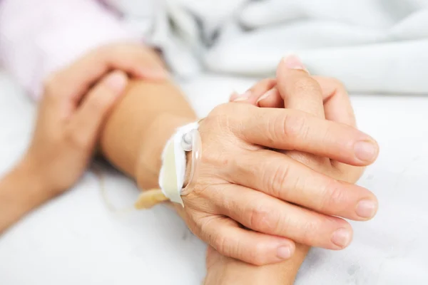 Dochter houdt van haar moeder hand in het ziekenhuis — Stockfoto