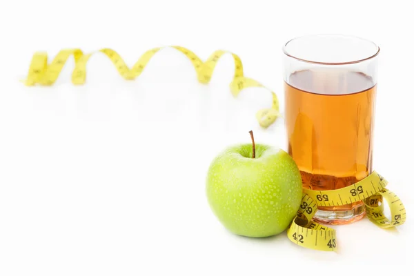 Green apple and juice with measuring tape — Stock Photo, Image