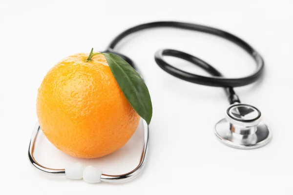 Orange i stethocscope — Zdjęcie stockowe