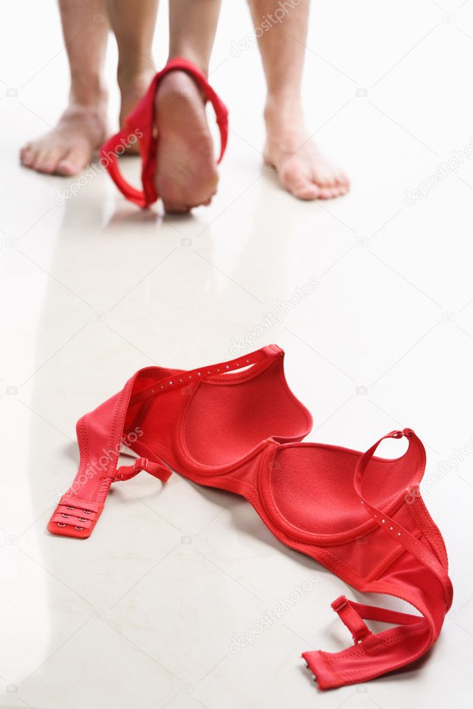 Couple having intercourse with red bra on floor