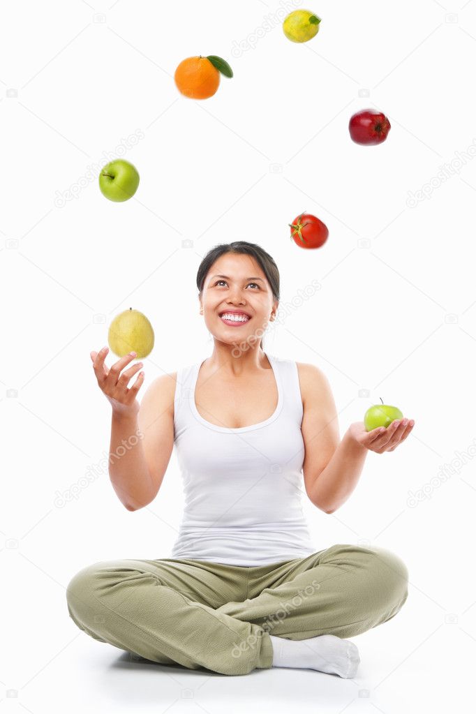 Asian woman juggling fruits