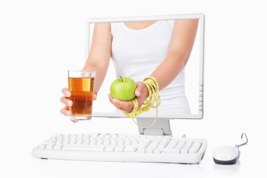 Female hand holding green apple and juice coming out from comput clipart