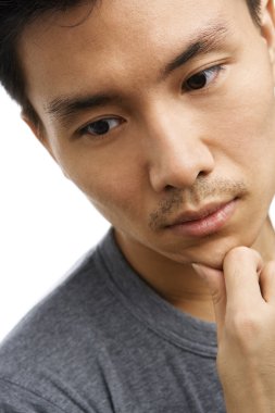 Sad expression of Asian young man clipart