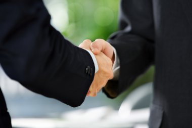 Handshake between two businessmen clipart