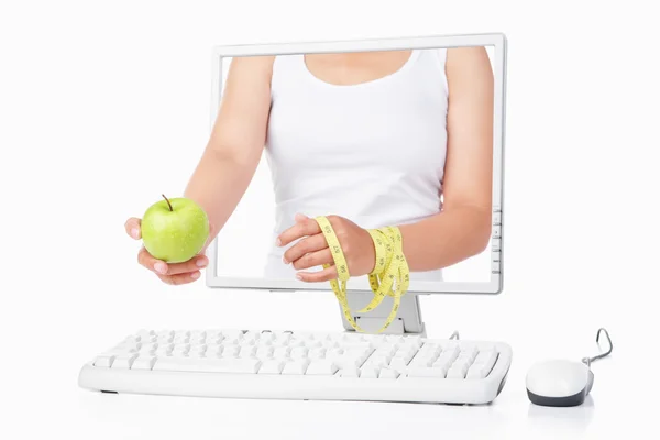 Female hand holding green apple and measuring tape coming out fr — Stock Photo, Image