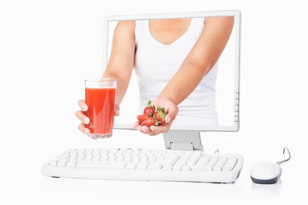 Female hand holding strawberry and juice coming out from compute — Stock Photo, Image