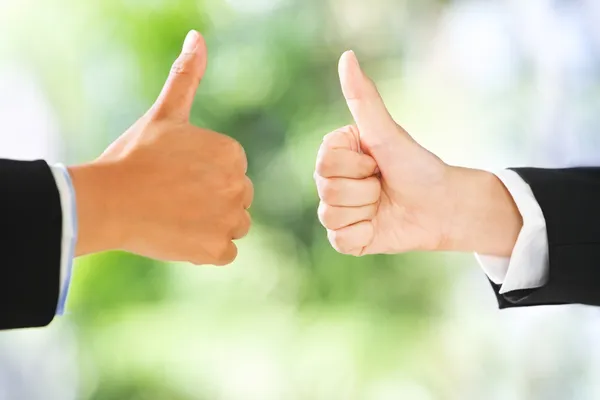 Thumbs up over green background — Stock Photo, Image