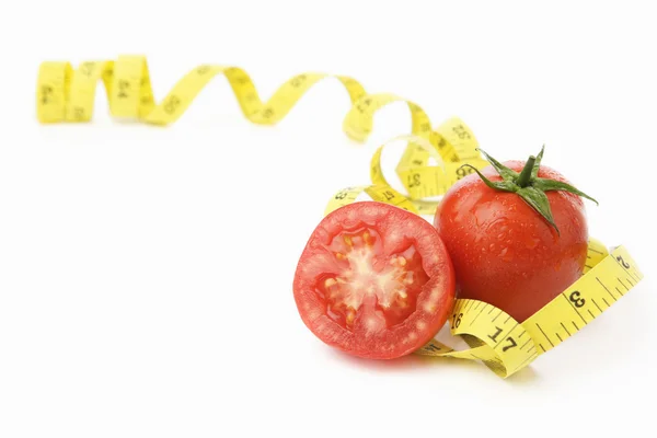 Tomatoes with measuring tape — Stock Photo, Image
