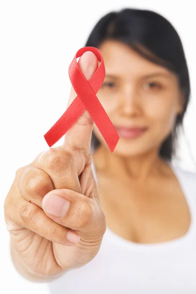 Woman pointing red ribbon badge to camera — Stock Photo, Image