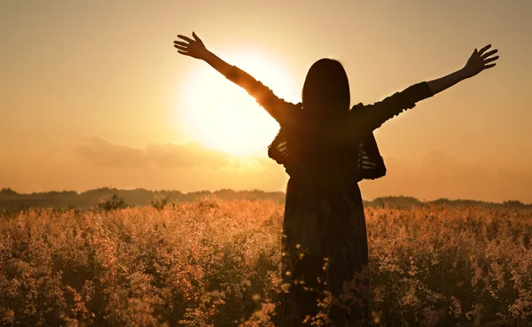 Woman silhouette waiting for summer sun — Stock Photo © OtnaYdur #11051826