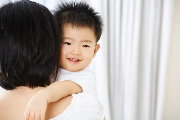 Asian toddler on her mother hug — Stock Photo, Image