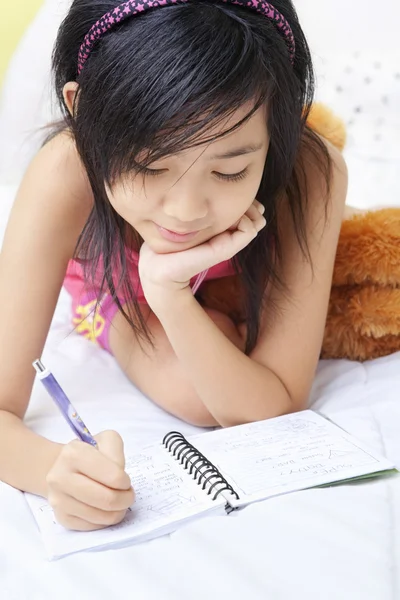 Little girl writing her diary — Stock Photo, Image