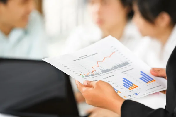 Examining graphs with other on background — Stock Photo, Image