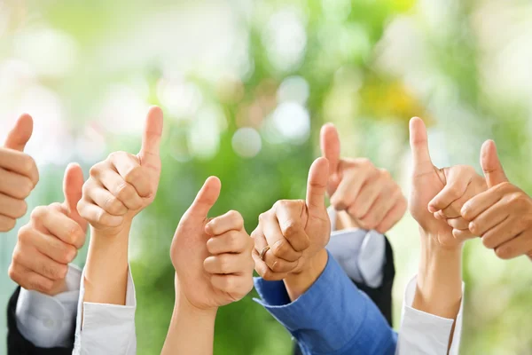 Thumbs up on green background — Stock Photo, Image