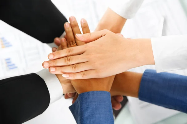 Líder y sus empleados manos en la unidad — Foto de Stock