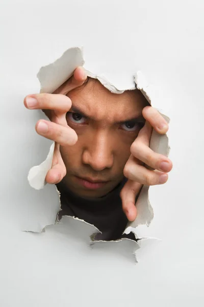 Man with scary look from cracked wall — Stock Photo, Image