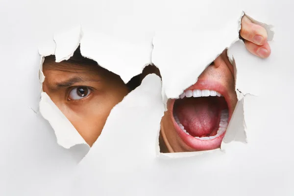 One peeking and the other screaming from the hole in wall — Stock Photo, Image