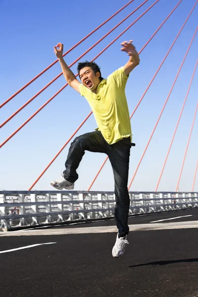 stock image Young man jump with wierd expression