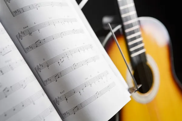 Musical chords and guitar on background — Stock Photo, Image