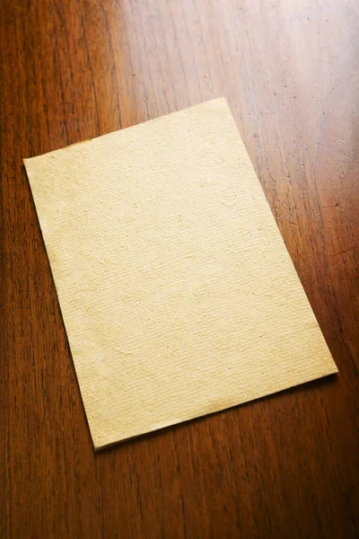 Old blank paper and scroll on wooden table — Stock Photo, Image
