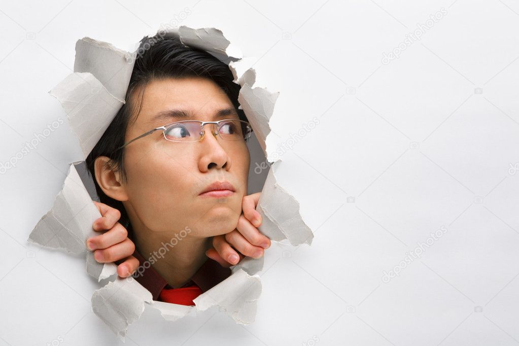 Man from hole in wall looking away to his left side