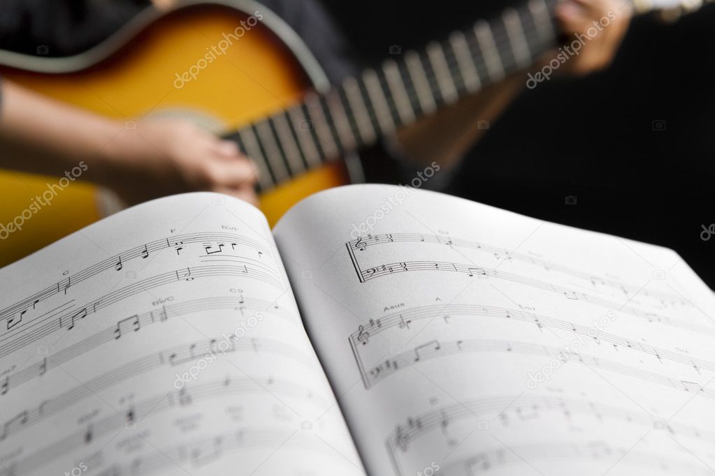 playing guitar with musical chords